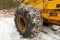 Close up of Winter Chains on Yellow Logging Skidder