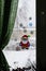 Close-up of a winter New Year`s decor for a window in the form of a Santa Claus on the background of a window with drops from sle