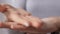 Close up of woman applying moisturizing hand cream