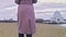 Close-up of woman in autumn boots walking on sand. Stock footage. Beautiful young woman walks along beach sand on cloudy