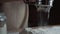 Close up woman bakery chef sifting flour from sieve on table, preparing for making homemade bread. Slow motion shot.