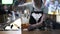 Close up of a woman bartender stirring ice in a jug