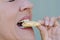 Close up woman biting sweet cookie snack