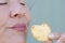 Close up woman biting sweet cookie snack closed eyes