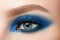 Close-up of woman blue eye with beautiful blue smokey eyes makeup