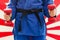 Close Up of Woman in Blue Judo Gi, and Black Belt, which is Trai