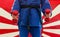 Close Up of Woman in Blue Judo Gi, and Black Belt, which is Trai