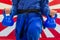Close Up of Woman in Blue Judo Gi, and Black Belt, which is Trai