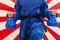 Close Up of Woman in Blue Judo Gi, and Black Belt, which is Trai