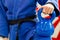 Close Up of Woman in Blue Judo Gi, and Black Belt, which is Trai