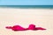 Close up of woman bra at nude beach. Concept of sunbathing naked on the sandy ocean beach. Naturalist lifestyle. Nobody