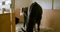 Close up of woman brushing horse indoor at a stable