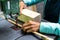 Close-up of a woman carpenter cutting a block of wood with a band saw