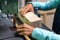 Close-up of a woman carpenter cutting a block of wood with a band saw