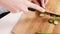 Close up on a woman carving a cucumber