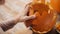 Close up of woman carving halloween pumpkin