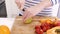 Close up on a woman carving some fruits