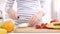 Close up on a woman carving some fruits