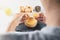 Close-up of woman chef breaking an egg into the wood bowl. Cooking concept.