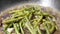 Close up of a woman cooking eggplant and garlic green bean hot pot