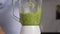 Close up of Woman Cooking Green Detox Smoothie