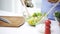 Close up of woman cooking vegetable salad at home