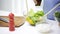 Close up of woman cooking vegetable salad at home