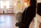 Close up of woman with cremation urn in church