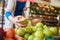 Close Up Of Woman Customer With Basket Buying Fresh Apples In Organic Farm Shop