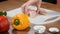 Close-up woman cuts chicken fillet with a ceramic knife on a wooden Board. Female hands chef cutting raw chicken meat