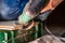 Close up of woman cutting laminate of wooden floor