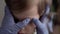 Close up woman doctor dermatologist in blue gloves squeezes out pimple 3-4 years minor preschool boy kid. Over the