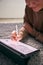 Close Up Of Woman Drawing On Digital Tablet Using Stylus Pen Lying On Carpet At Home