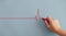 Close up Woman drawing heartbeat with red chalk on wall.