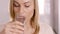 Close up on a woman drinking a glass of water