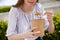 Close Up Of Woman Eating Healthy Vegan Or Vegetarian Soup As Takeaway Lunch From Recyclable Packaging With Wooden Spoon