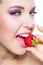 Close up of woman eating strawberry