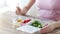 Close up of woman eating vegetables from container