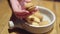 Close-up of a woman eats walnut shaped cookies with condensed milk - sweet Russian dessert.