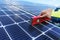 Close-up of woman engineer measuring solar photovoltaic panels on roof, alternative energy concept.