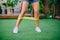 Close up woman is exercising with resistant band on lawn