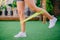 Close up woman is exercising with resistant band on lawn