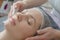Close-up woman face in beauty spa on couch. Relaxation, rejuvenation