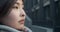 Close-up of woman face. Portrait of a beautiful young Asian woman standing against the backdrop of a business center in