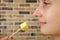 Close-up of woman face. Woman eating parmesan cheese