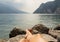 Close up of woman feet relaxing by a beautiful big lake lying on the edge of rocks