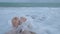 Close up of a woman feet on a sandy beach with sea.