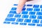 Close up woman finger on enter button blue keyboard cover