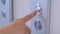 Close up: woman finger pressing elevator up button - moving up concept