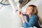 Close-up Of Woman Fixing Sink Pipe With Wrench